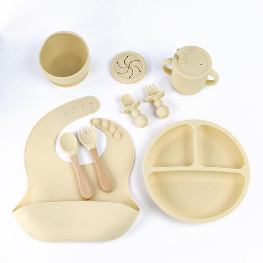 Beige 8-Piece Silicone Children's Tableware Set - BPA-Free Baby Feeding Utensils with Wooden Fork and Spoon, Cup, Bowl, and Bibs.