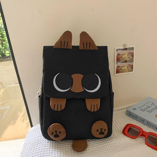 Black Lightweight Nylon Waterproof Schoolbag for Children - Large Capacity Daypack with Ugly-Cute Cat Design.